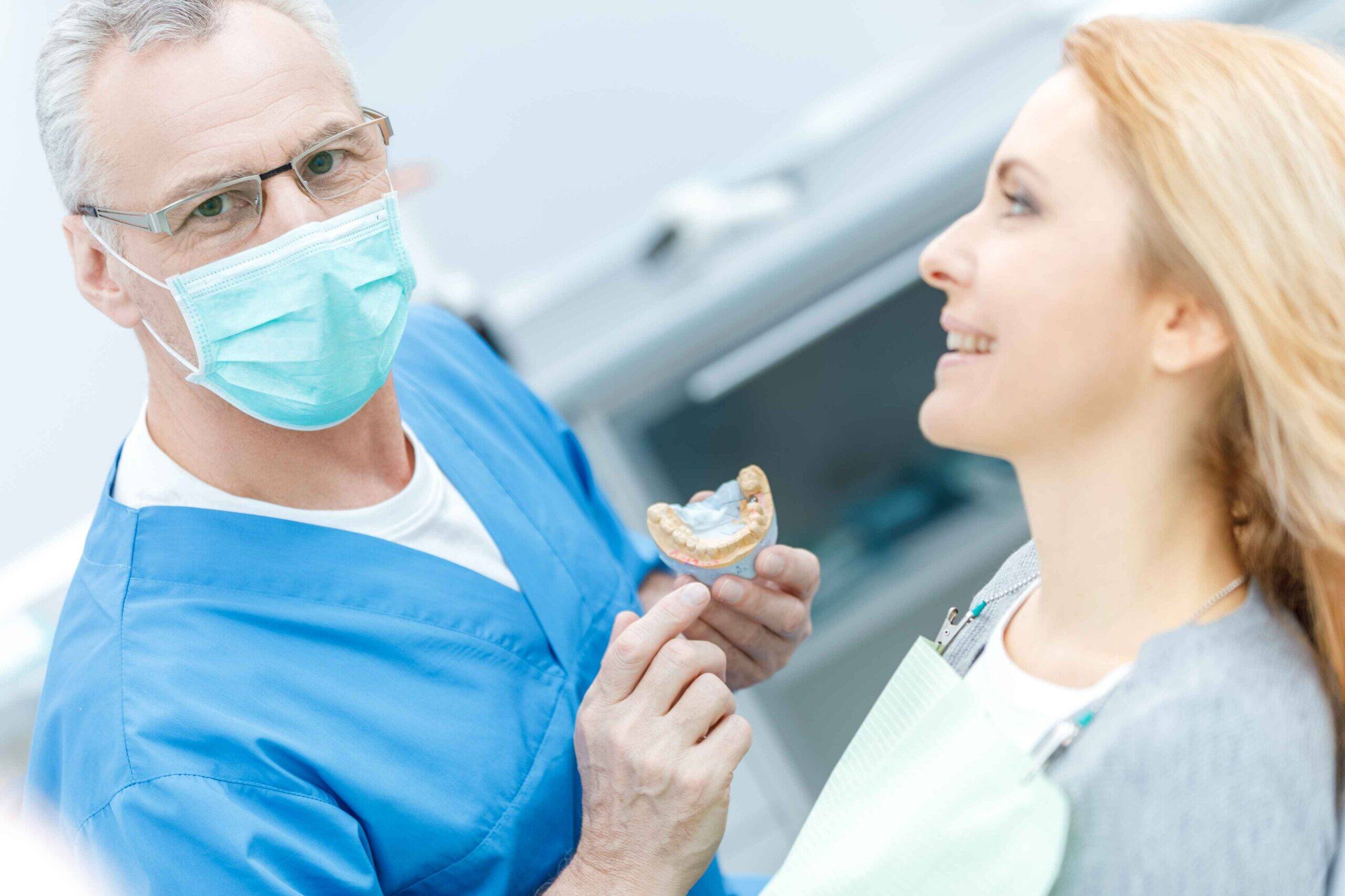 Dentist discussing denture options with a patient during a consultation.