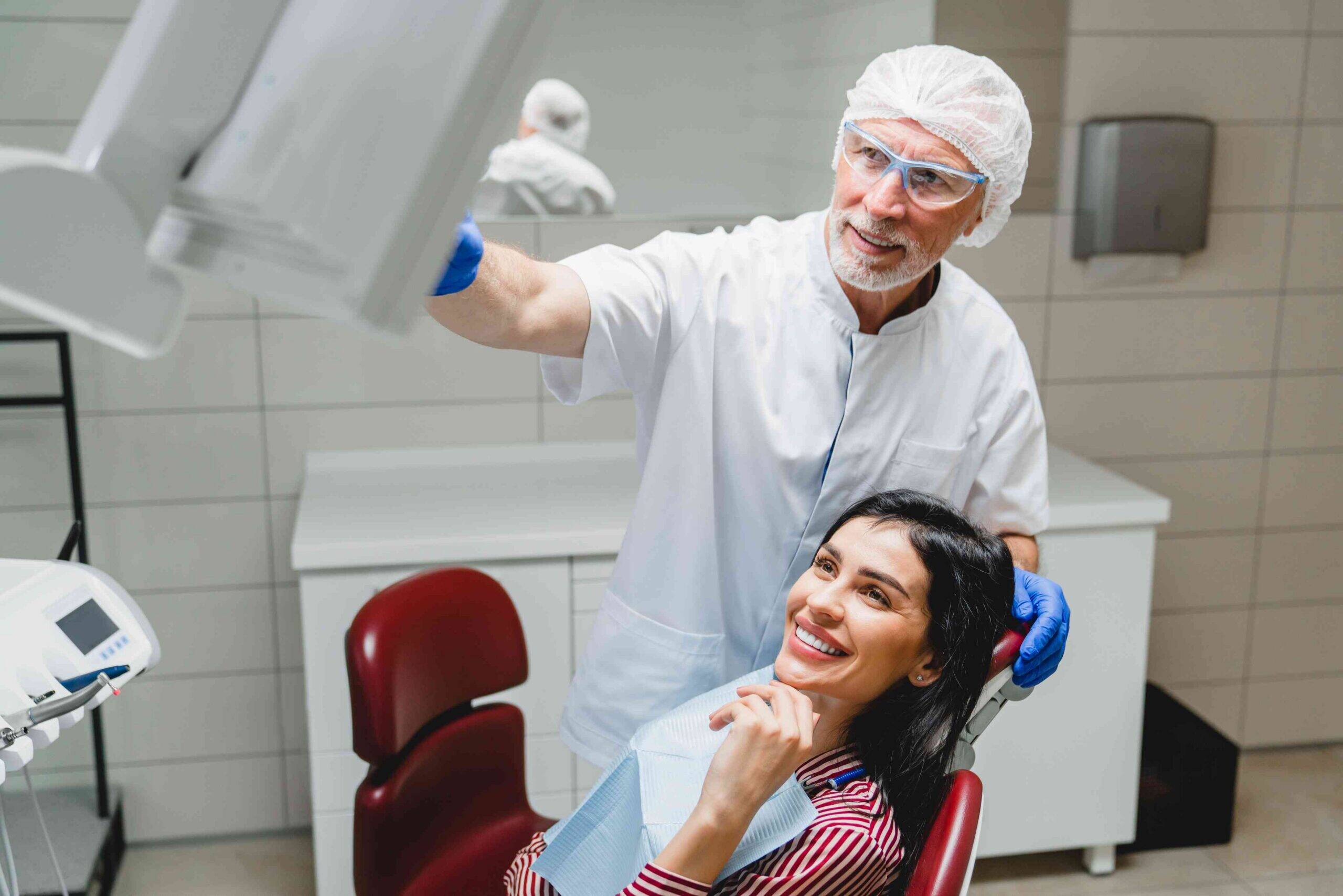 Dentist discussing treatment with a smiling patient.